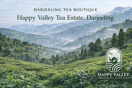 Happy Valley Tea Estate Darjeeling banner with green tea gardens, misty hills, and organic tea branding.