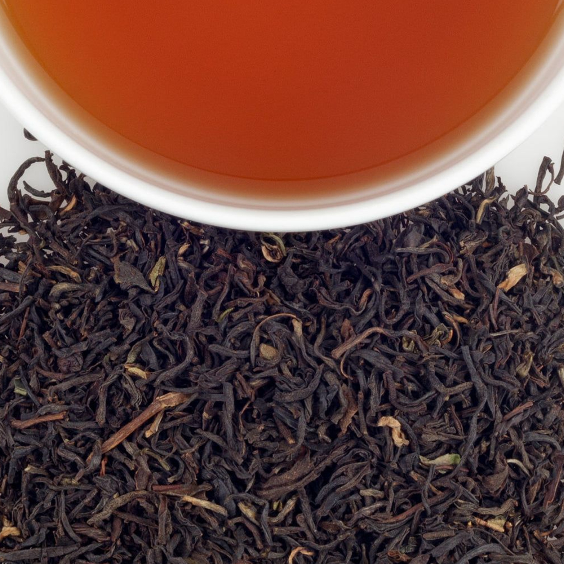 Deep amber vintage Darjeeling tea liquor photographed in cup.