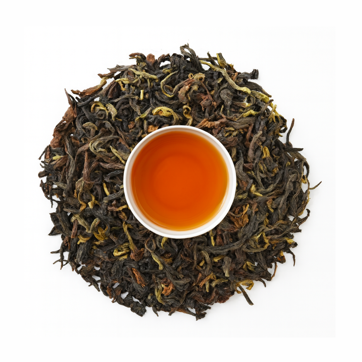 Top view of vintage Darjeeling tea leaves with brewed amber infusion.